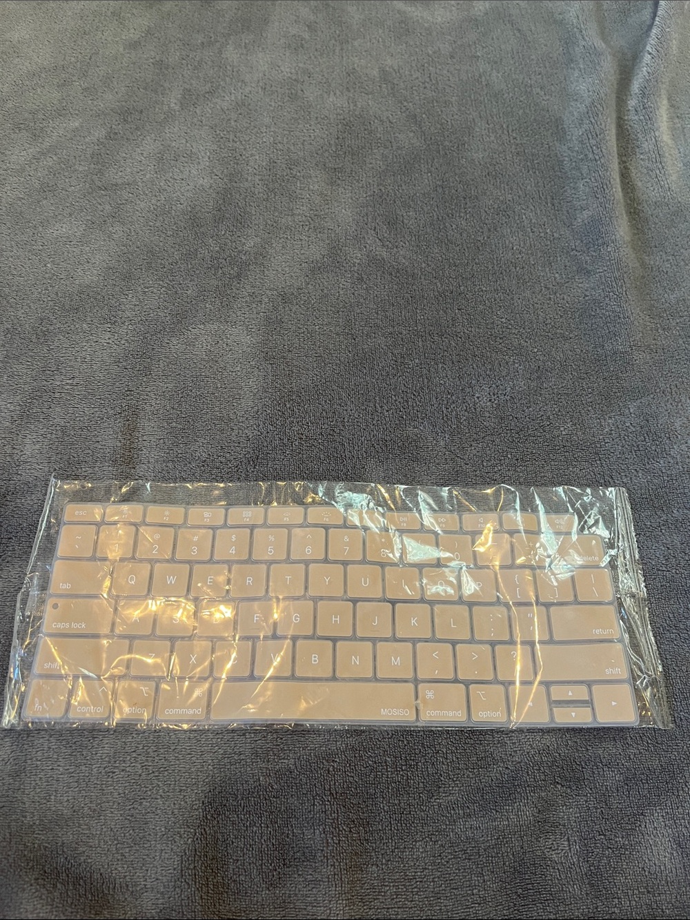 beige keyboard cover for Apple laptop- not sure which model